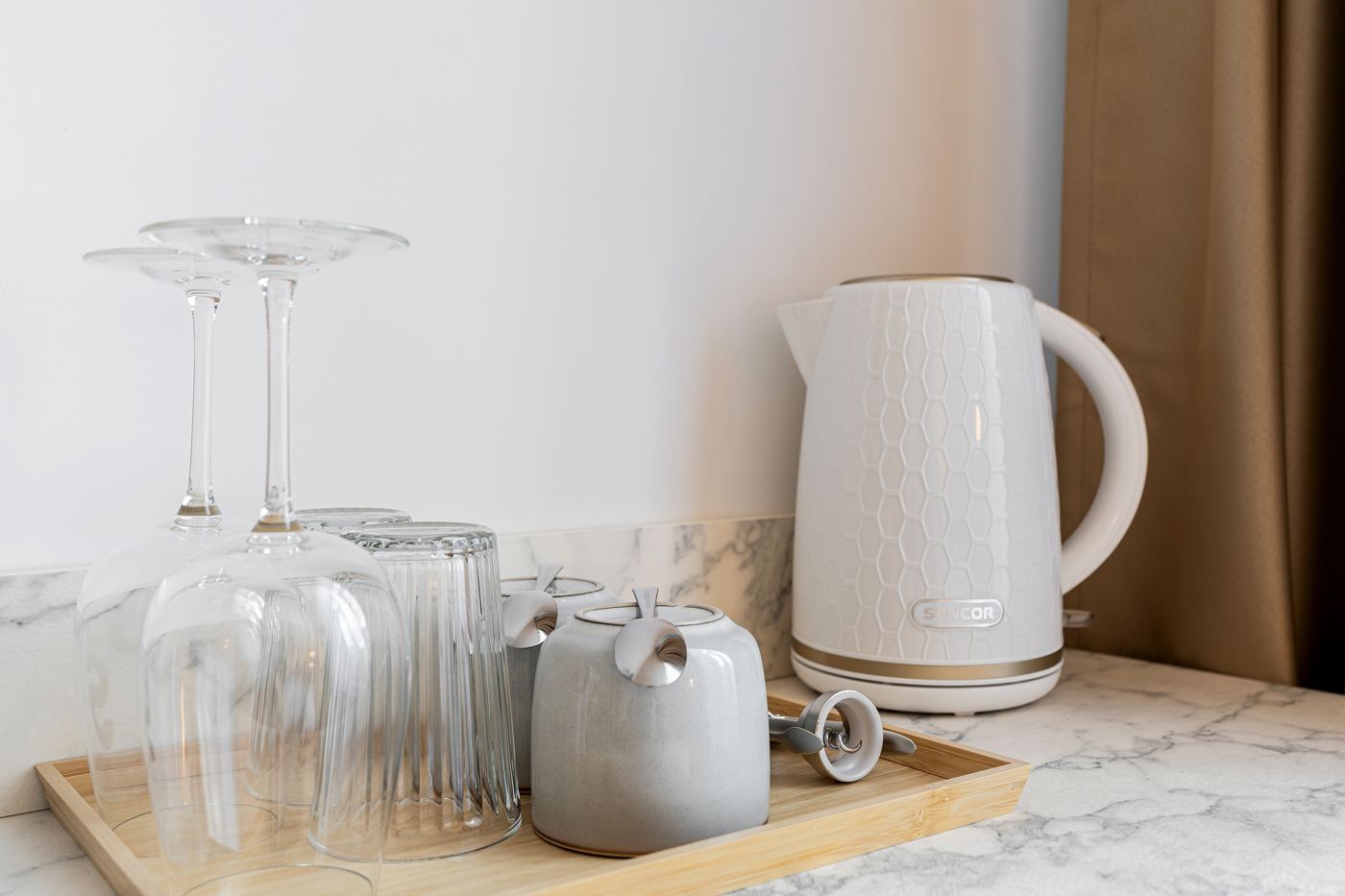 Kettle, cups and glasses on a wooden tray